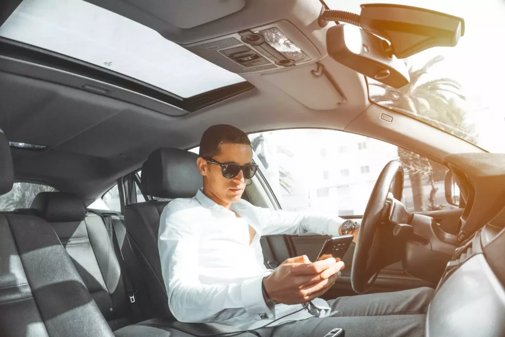 A man on his phone while driving.