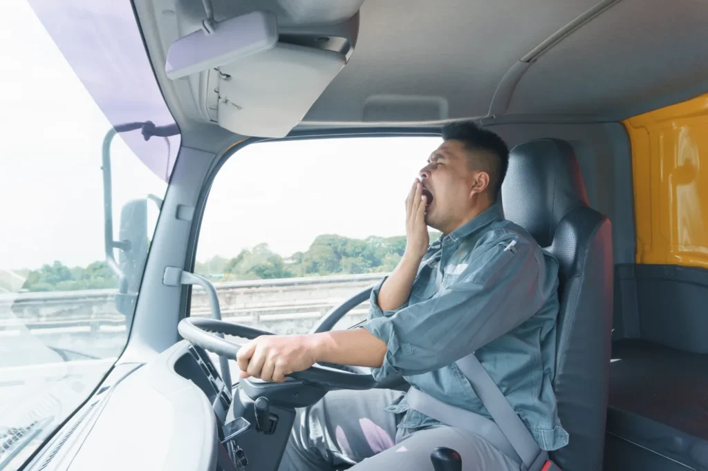 A tired truck driver on the road.