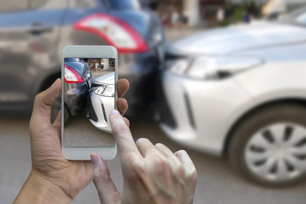 Taking a photo of a car accident.