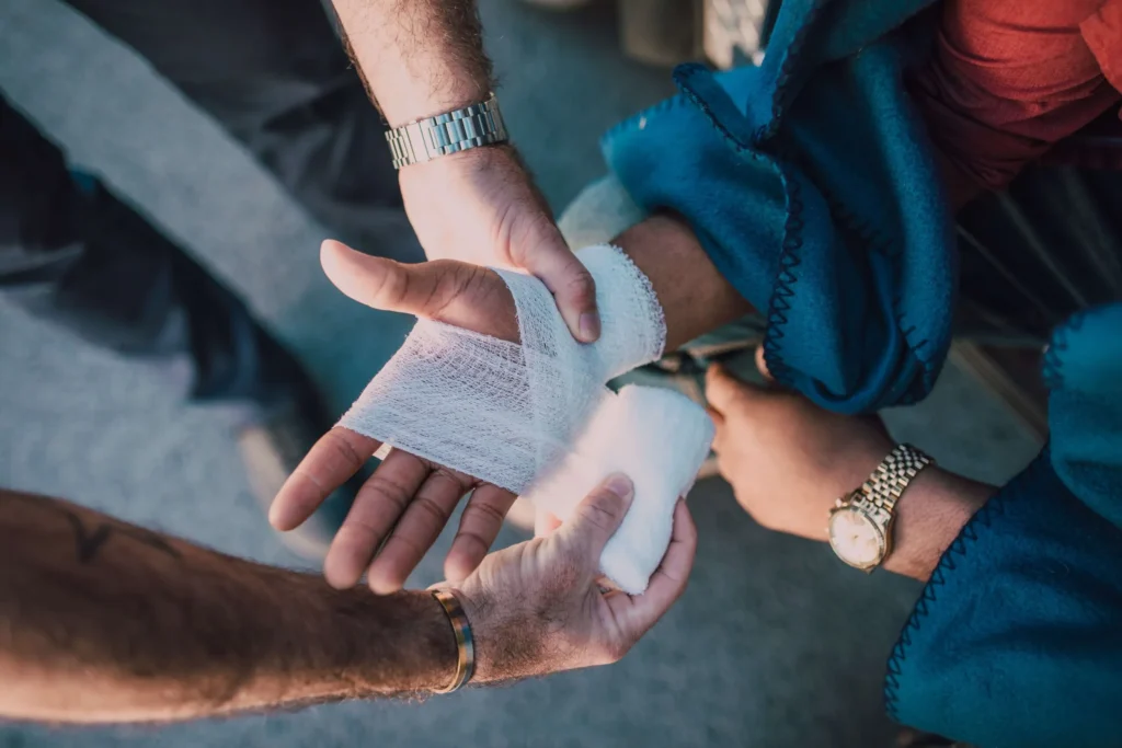 Someone wrapping someone else's wrist in a bandage