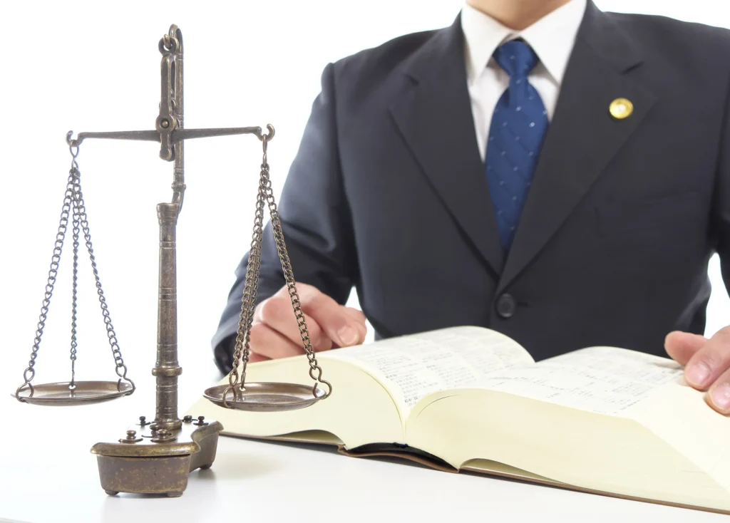 An attorney working at his desk with justice scales.