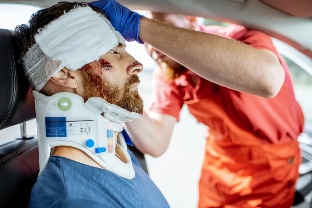 A man in a neck collar after a traumatic car accident.